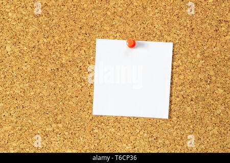 Cork board with pinned blank notepaper. Stock Photo