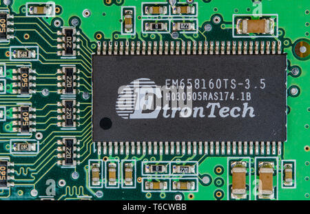 Dual in line (DIL or DIP) package surface mount technology (SMT) EtronTech chip mounted in a PCB. Electronics circuit board macro closeup. Stock Photo