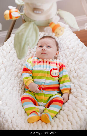 Cute adorable smiling white Caucasian baby boy girl lying in