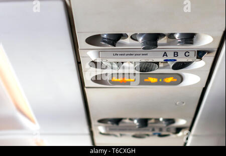 Control panel to regulate the direction of personal lights, air conditioning, with the indication of smoking ban and to keep the safety belts fastened Stock Photo