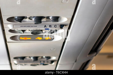 control panel to regulate the direction of personal lights, air conditioning, with the indication of smoking ban and to keep the safety belts fastened Stock Photo