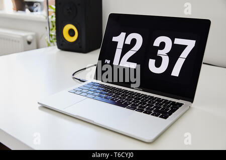 Apple Macbook Pro Notebook With The Clock Screensaver On The Big