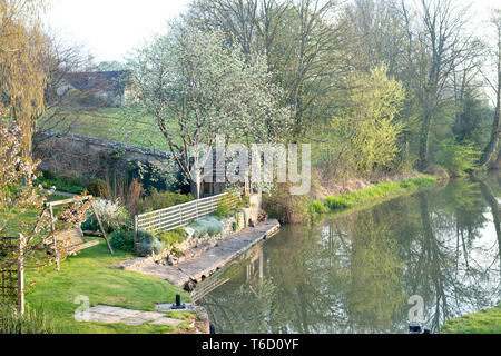 Oxford canal and tree reflections in the early morning spring sunlight. Shipton on cherwell, Oxfordshire, England Stock Photo