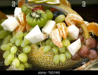 A variety of fruits in the basket of pumpkins. Stock Photo