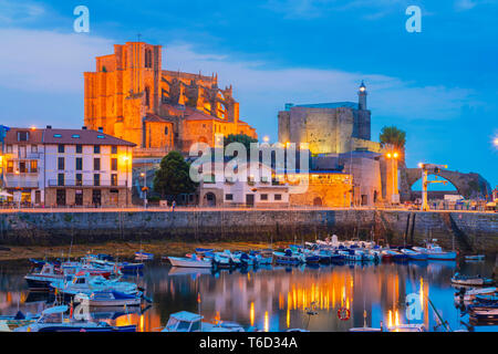Spain, Cantabria, Castro-Urdiales, harbour, Santa Maria church and Santa Ana castle at dusk