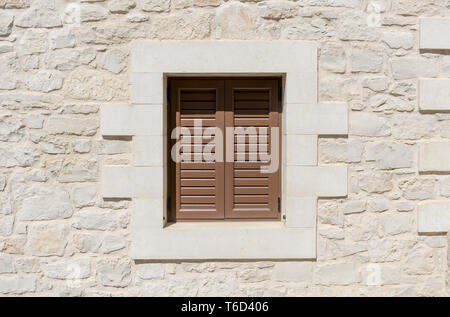 Window with brown shutter and a natural stone wall Stock Photo - Alamy