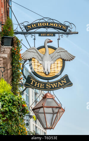 Ornate pub sign for The Swan public house in Hammersmith Broadway. Stock Photo