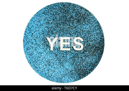 Mixed black and blue decorative sand with applied wooden letters with the word YES isolated on white. Stock Photo