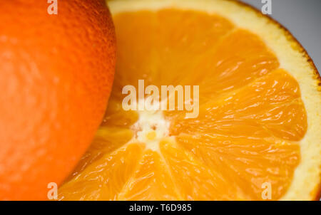 Macro Closeup of fresh juicy orange split in two halves one side reversed with good texture of pulp and peel Stock Photo