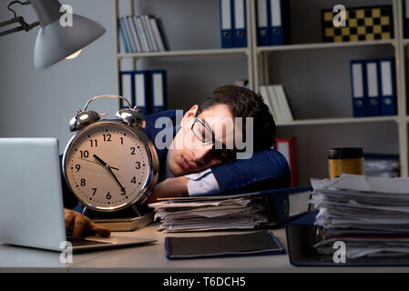 Businessman falling asleep during long hours in office Stock Photo