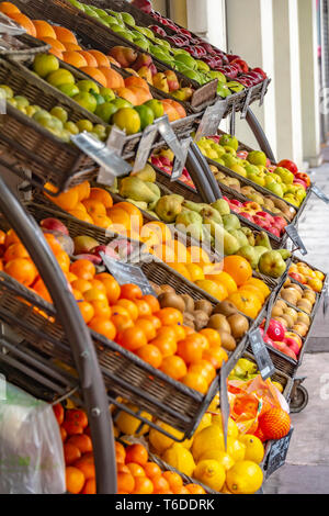 Nice, France - October 6, 2018: Baskets of fruit standing on a shelf in front of a shop on the sidewalk. Stock Photo