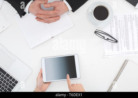 Two business people sitting at office top view close-up woman browsing digital tablet looking for creative ideas Stock Photo
