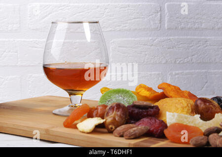 mix of dried fruits and nuts on a dark wood background. tinting. selective focus Stock Photo