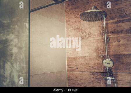 Modern Bathroom Shower Cabin with Wooden Like Ceramic Tiles and Glass Walls. Stock Photo