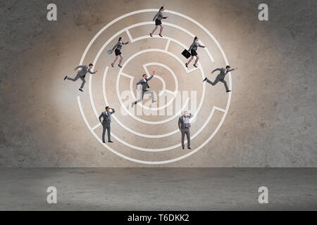 Business people getting lost in maze uncertainty concept Stock Photo