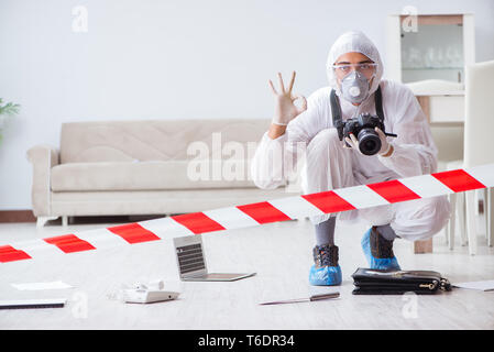 Forensic expert at crime scene doing investigation Stock Photo