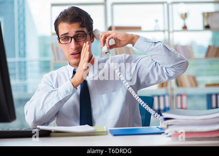 Businessman suffering from excessive armpit sweating Stock Photo