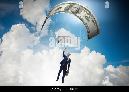 Businessman in golden parachute concept Stock Photo