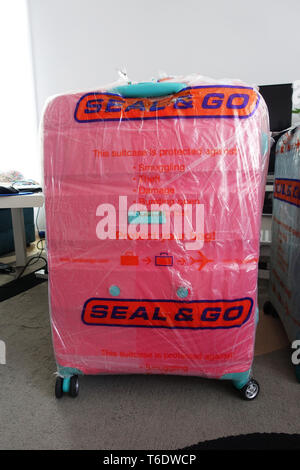 Seal and Go airline luggage bag wrapper Stock Photo
