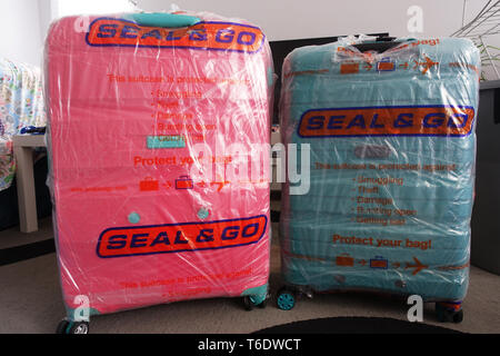Seal and Go airline luggage bag wrapper Stock Photo