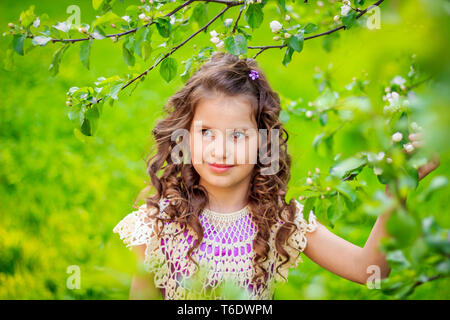 Girl and apple tree branches. Flowering fruit tree. White flowers. beautiful girl. Russia, Gatchina, May 17, 2018 Stock Photo