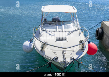 small yacht docking in a harbor Stock Photo