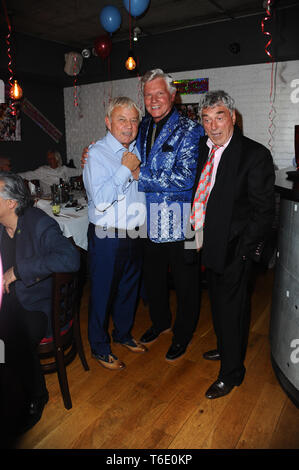 Frazer Hines, Jess Conrad and Billy Murray seen during the 70th birthday of Elaine Murray with friends and family at Pepenero restaurant in Camden London. Stock Photo