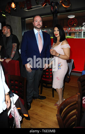 Jonathan Sothcott and Janine Nerissa seen during the 70th birthday of Elaine Murray with friends and family at Pepenero restaurant in Camden London. Stock Photo