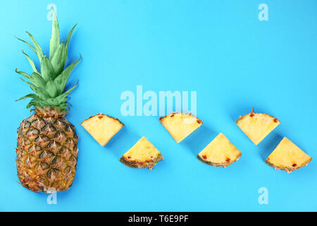 Composition with whole and sliced fresh pineapples on color background Stock Photo
