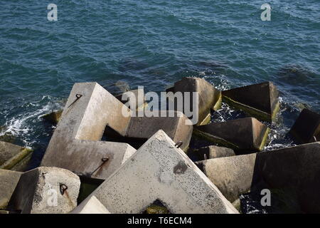 Breakwater of the rectangular stone figures. Stock Photo