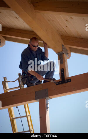 Focused builder working on a construction site. Stock Photo