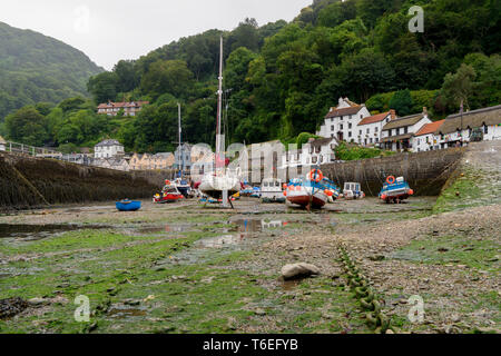 Lynmouth harbour in Devon at low tide with boats in the foreground Stock Photo