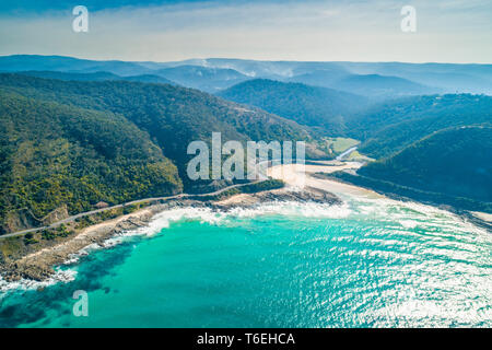 Great Ocean Road passing along scenic coastline on bright sunny day Stock Photo