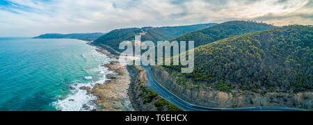 Great Ocean Road passing through scenic landscape in Victoria, Australia - aerial panoramic landscape Stock Photo