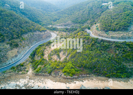 Great Ocean Road bends through hills near the coastline Stock Photo