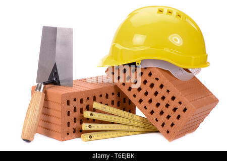 brick for house construction and tools isolated over white background Stock Photo