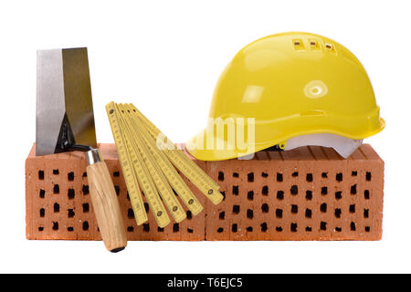 brick for house construction and tools isolated over white background Stock Photo