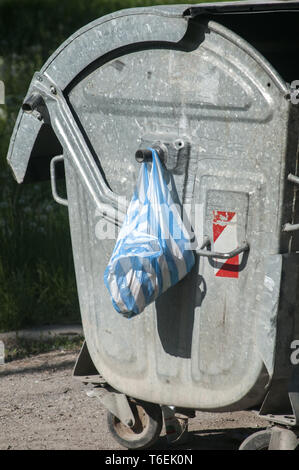 Mobile metal garbage container in countryside Stock Photo