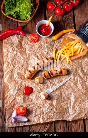 rustic bratwurst with pommes and hot ketchup Stock Photo