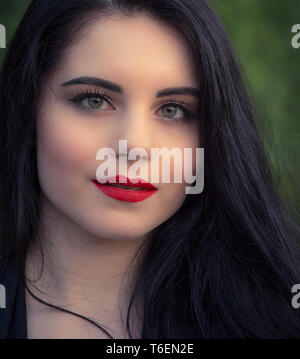 Dark-haired young woman wearing hot pants, a black leather jacket