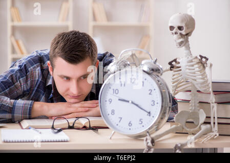 Student and skeleton preparing for school exams Stock Photo