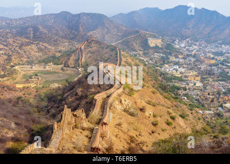Ancient long wall with towers around Amber Fort, view from Jaigarh Fort. Jaipur. Rajasthan. India Stock Photo