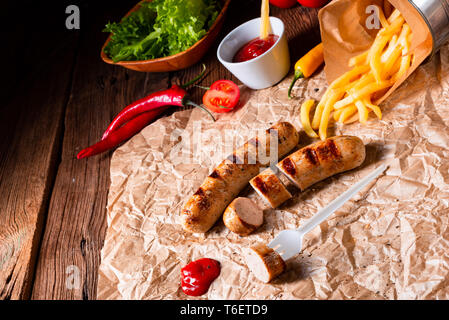 rustic bratwurst with pommes and hot ketchup Stock Photo