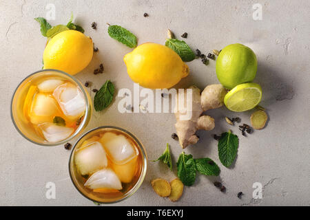 Flat lay composition with glasses of cold lemon tea and ginger on table Stock Photo
