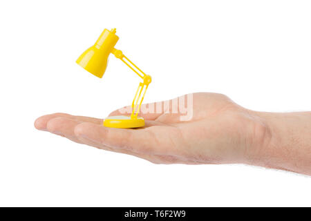 Hand with small desk lamp Stock Photo