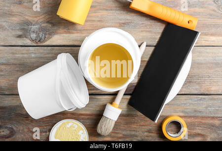 Paint cans and tools on wooden table Stock Photo