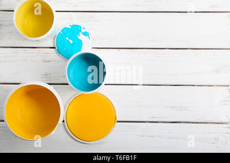 Paint cans on wooden table Stock Photo