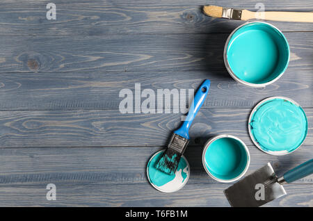 Paint cans and tools on wooden table Stock Photo