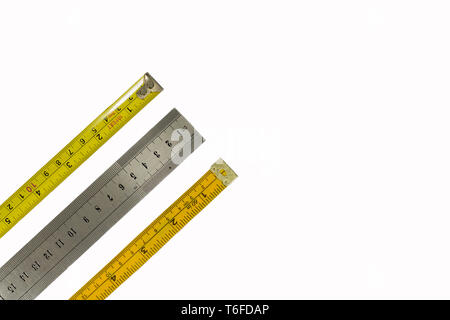 Tape measure, stainless steel ruler and dressmakers tape measure, isolated on a white background. Different industries, measurements concepts Stock Photo