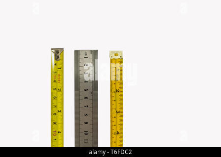 Tape measure, stainless steel ruler and dressmakers tape measure, isolated on a white background. Different industries, measurements concepts Stock Photo